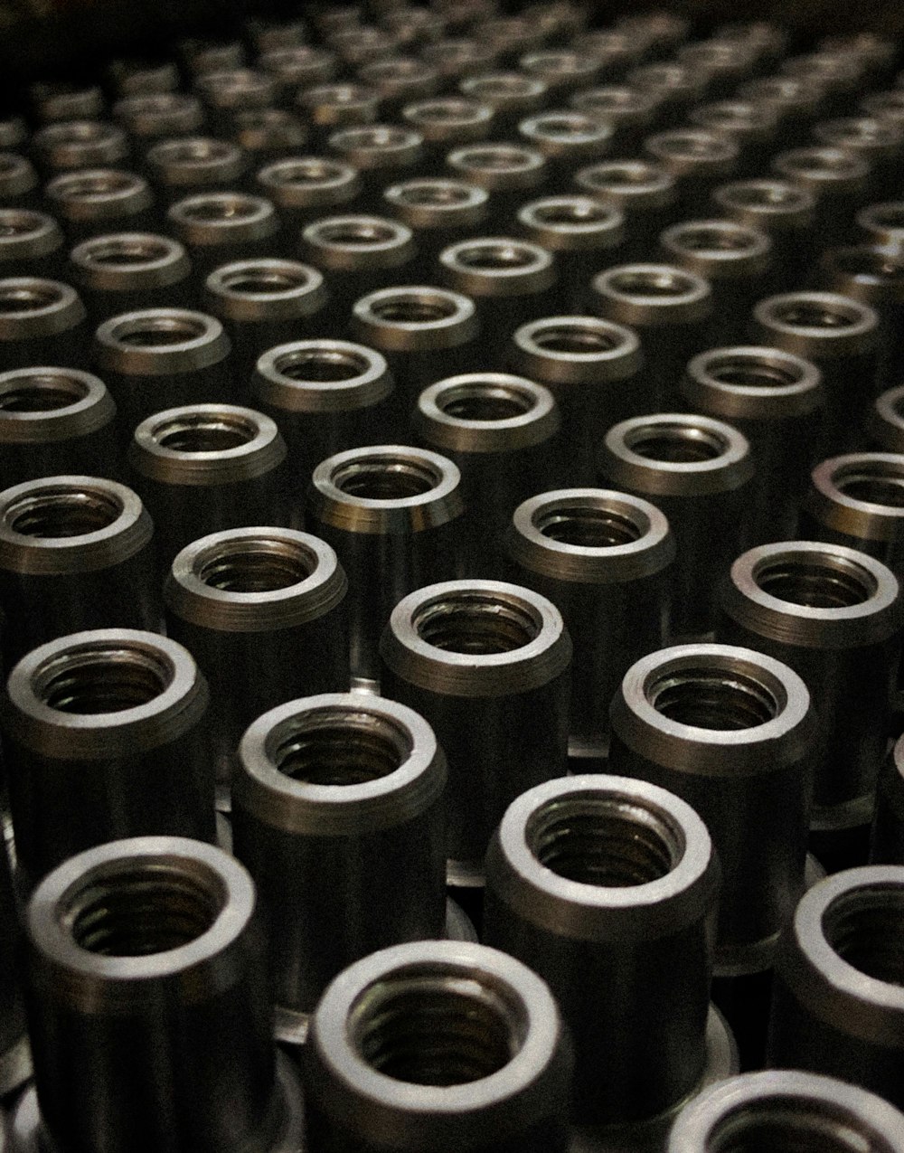 Rows of precision-machined steel rings on a workbench