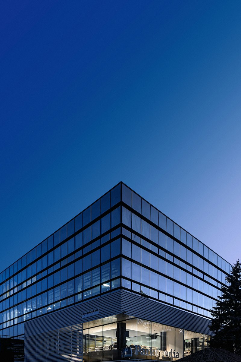 Modern glass-fronted office building at dusk